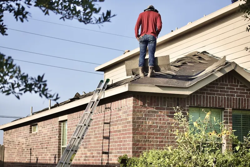 Professional roofer working on a residential roof in Williamsburg